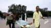 Paramedics and civilians carry an injured person on a stretcher at Madina hospital after a blast at the Elite Hotel in Lido beach in Mogadishu, Somalia, Aug. 16, 2020. 