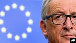 FILE - European Commission President Jean-Claude Juncker listens to questions during a media conference at the conclusion of an EU summit in Brussels, Oct. 20, 2017. 