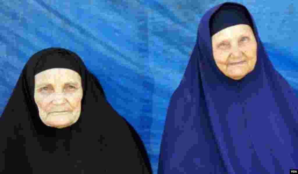 Two women at Rabaa al Adaweya await an expected government siege, Cairo, August 12, 2013. (E. Arrott/VOA)