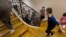 Children walk toward their classroom at the Cour de Lorraine elementary school in Mulhouse, eastern France, on its reopening day for pupils, May 18, 2020, as France eases lockdown measures taken to curb the spread of COVID-19.