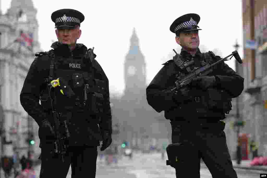 Armed police officers secure the area near the Houses of Parliament in central London on March 23, 2017 the day after the March 22 terror attack in Westminster claimed at least three lives.