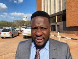 Paidamoyo Saurombe from Zimbabwe Lawyers for Human Rights speaks to VOA outside Harare Magistrates Court on Oct. 29, 2021 after he successfully secured the war veterans’ release on bail. (Columbus Mavhunga/VOA)