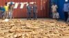 This photo taken on Dec. 13, 2018 shows Cambodian Customs and Excise Officials looking at ivory seized from a shipping container at the Phnom Penh port.