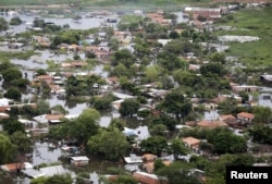 Houses are seen partially submerged in floodwaters in Asuncion, Paraguay, Dec. 28, 2015.