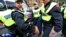 British police officers arrest anti-fascist demonstrators protesting against members of the British National Party [not seen], during a demonstration over the May 22 murder of soldier Lee Rigby by Muslim extremists, in central London, June 1, 2013.