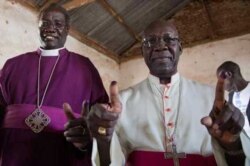 Archbishop Daniel Deng Bul of the Episcopal Church of Sudan and<br>Catholic Archbishop Paulino Lukudu Loro (right) vote recently in the referendum on independence.