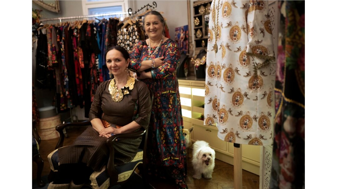 Erika and Helena Varga pose for photographs in their fashion studio, Romani Design, in Budapest, Hungary, Dec. 12, 2021.