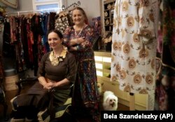 Erika and Helena Varga pose for photographs in their fashion studio, Romani Design, in Budapest, Hungary, Dec. 12, 2021.