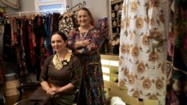 Erika and Helena Varga pose for photographs in their fashion studio, Romani Design, in Budapest, Hungary, Dec. 12, 2021.