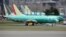 FILE - Boeing 737 Max aircraft, including a 737 Max 8 aircraft bearing the logo of China Southern Airlines (3rd left), are parked at a Boeing production facility in Renton, Washington, March 11, 2019.