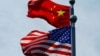 FILE - A Chinese and U.S. flag flutter in Shanghai, China, July 30, 2019.
