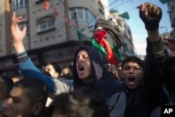 Palestinians chant in protest during a demonstration against the chronic power cuts in Jabaliya refugee camp, northern Gaza Strip, Jan. 12, 2017.