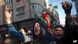 FILE - Palestinians chant in protest during a demonstration against the chronic power cuts in Jabaliya refugee camp, northern Gaza Strip, Jan. 12, 2017.