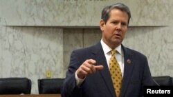 FILE - Georgia Secretary of State Brian Kemp speaks with visitors to the state capitol about the "SEC primary" involving a group of southern states voting next month in Atlanta, Feb. 24, 2016.