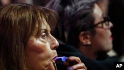 A woman blows a whistle during a protest against the president of Serbia in 2018. (AP Photo/Darko Vojinovic)