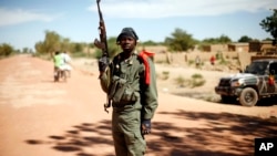 A Malian soldier mans a checkpoint on the outskirt of Diabaly, some 460kms (320 miles) north of Bamako, January 21, 2013.