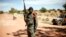 A Malian soldier mans a checkpoint on the outskirt of Diabaly, some 460kms (320 miles) north of Bamako, January 21, 2013.