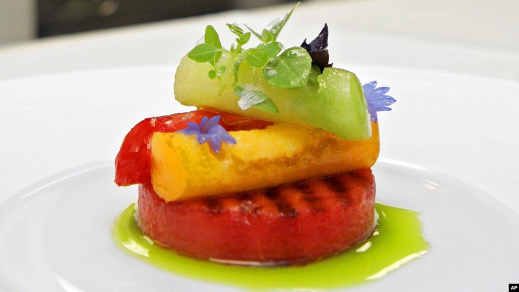 This June 19, 2006 file photo shows an appetizer of grilled watermelon topped with tomatoes, basil and aged balsamic vinegar at Eleven Madison Park in New York. The restaurant announced it will no longer serve meat. (AP Photo/Richard Drew, File)