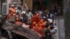 Rescuers work at the site of a building that collapsed in Mumbai, India, Tuesday, July 16, 2019. 