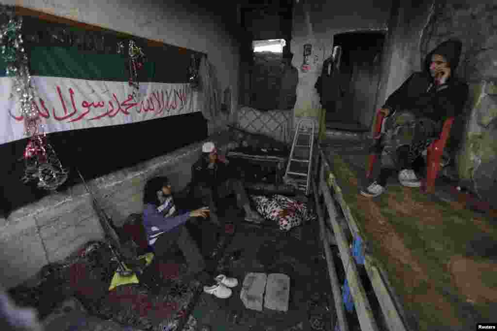 Free Syrian Army fighters rest in a safehouse in the Mouazafeen neighbourhood in Deir al-Zor, Nov. 10, 2013. 