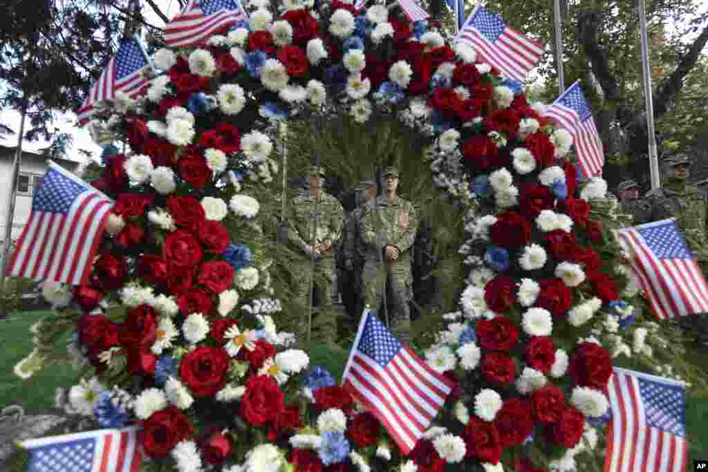 U.S. and NATO soldiers stand guard during a ceremony to commemorate the Sept. 11, 2001 terrorist attack on the World Trade Center in New York, in Resolute Support headquarters, in Kabul, Afghanistan, Sept. 11, 2017.