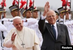 Pope Francis and Peru's President Pedro Pablo Kuczynski wave, in Lima, Peru, Jan. 18, 2018.