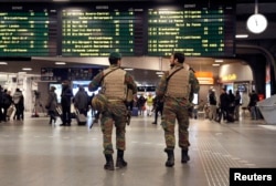 Belgian soldiers patrol in the arrival hall at Midi railway station in Brussels after security was tightened in Belgium following the fatal attacks in Paris, Nov. 21, 2015.