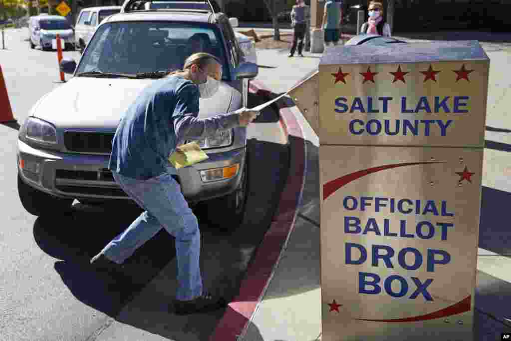 Chris Tapscott inserts his ballot in a ballot drop box Tuesday, Oct. 20, 2020, in Salt Lake City. (AP Photo/Rick Bowmer)