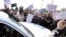 A striking municipal police officer reacts as he leans on a car with a Greek flag during a protest, against new austerity cuts that will affect thousands of public sector workers, in Athens. The government has committed to firing 15,000 people by the end of 2014 and transferring another 12,500 to new positions this year.