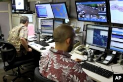 Hawaii Emergency Management Agency officials work at the department's command center in Honolulu on Dec. 1, 2017. A siren blared across Hawaii on Friday in an effort to prepare tourists and residents for a possible nuclear attack from North Korea.