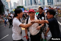 FILE - Protestors argue outside government offices in Hong Kong October 9, 2014.