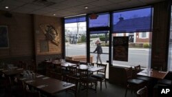 Clean tables await customers at the Eden Wok restaurant in New Rochelle, N.Y., March 12, 2020.