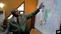 Azhari Abdalla, director general of the Sudanese oil ministry's Oil Exploration and Production Authority, points to a map as he briefs journalists in Khartoum, December 19, 2011.