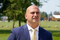 Dr. Nikolai Vitti, superintendent of Detroit Public Schools Community District, speaks during an interview outside Cody High School in Detroit on Friday, Aug. 20, 2021. (AP Photo/Carlos Osorio)