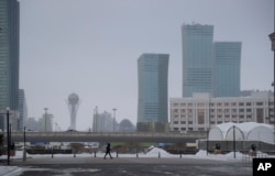 FILE - A resident walks in a street in Astana, Kazakhstan.