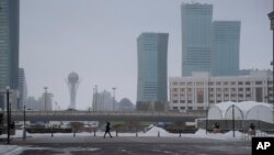 FILE - A resident walks in a street in Astana, Kazakhstan. The focus of the talks in Astana is a partial cease-fire that went into effect at the end of December.