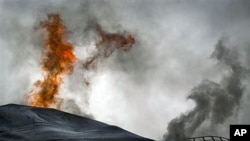 A fuel tank of a power station burns on the outskirts of the city of Ajdabiya, south of Benghazi, eastern Libya, March 21, 2011