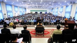 Teachers and students participate in a campaign by the National Election Committee, NEC, in Phnom Penh, Cambodia, Wednesday, May 9, 2018.