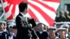 FILE - Japanese Prime Minister Shinzo Abe reviews members of Japan Self-Defense Forces (SDF) during the Self-Defense Forces Day at Asaka Base, north of Tokyo, Sunday, Oct. 27, 2013.