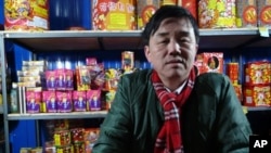 A fireworks seller in Beijing enjoys brisk trade as New Year celebrations get underway