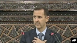 Syrian President Bashar al-Assad addresses the country's parliament in Damascus, March 30, 2011