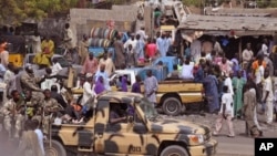 File - Nigerian soldiers ride on the back of an armed truck as they patrol at a local market Tuesday, Jan. 27, 2015, after recent violence in surrounding areas at Maiduguri, Nigeria. Islamic extremists are rampaging through villages in northeast Nigeria’s