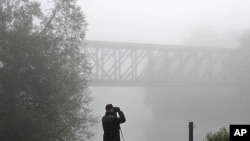 A member of the border police searches for illegal migrants on a railway bridge at the Schengen border with Croatia, June 20, 2011.