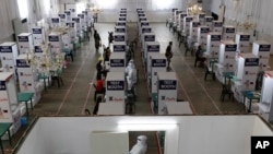 Health workers test for COVID-19 at a testing center at the Palacio de Manila in the Philippines during an enhanced community quarantine to prevent the spread of the new coronavirus on May 11, 2020. 