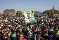 Supporters of the leader of the ruling Zambia Patriotic Front, incumbent president and candidate Edgar Lungu gather in Lusaka, on August 11, 2021 for a virtual closing rally ahead of tomorrow's general election. (Photo by Patrick Meinhardt / AFP)