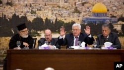 Palestinian President Mahmoud Abbas, center, speaks during a meeting with the Palestinian Central Council, a top decision-making body, at his headquarters in the West Bank city of Ramallah, Sunday, Jan. 14, 2018.