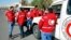 Staff from the Syrian Arab Red Crescent get ready to accompany a convoy of humanitarian aid as it waits in front of the United Nations Relief and Works Agency (UNRWA) offices before making their way into the government besieged rebel-held towns of Madaya, Zabadani and Moadimayet al-Sham in the Damascus countryside, as part of a U.N.-sponsored aid operation, in Damascus, Syria, Feb. 17, 2016.