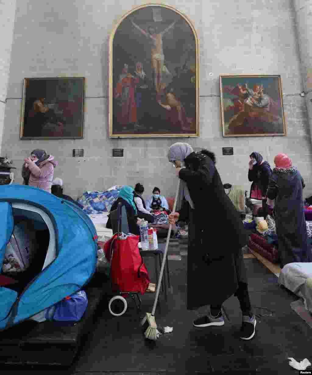 Illegal migrants, requesting to be regularized by the Belgian government to have access to heathcare, reside inside the Saint-Jean-Baptiste-au-Beguinage church during the COVID-19 outbreak, in Brussels, Belgium, Feb. 23, 2021.