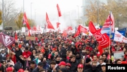 Trainees and employees of German carmaker Audi demand higher wages during a protest march in front of the company's headquarters in Ingolstadt, Germany, Oct. 29, 2024.