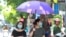 Women wearing face masks walk on the street in Hanoi, Vietnam, Thursday, July 30, 2020. Vietnam on Thursday reported several more cases of COVID-19, as the first outbreak in over three months spread to cities while authorities say they cannot trace…
